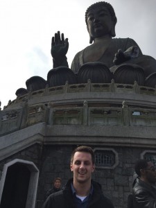 Adam at statue of Buddha