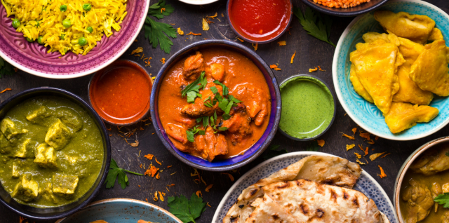 Many different types of Indian dishes on the table