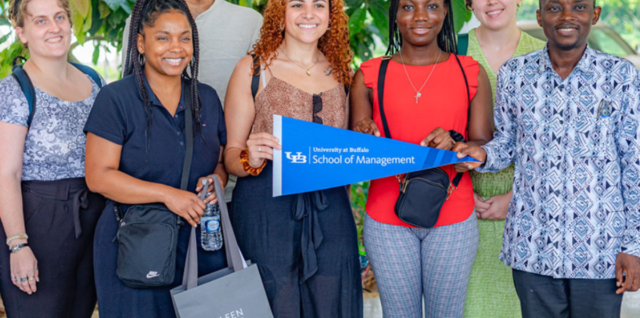 A group of University at Buffalo students standing together, smiling.