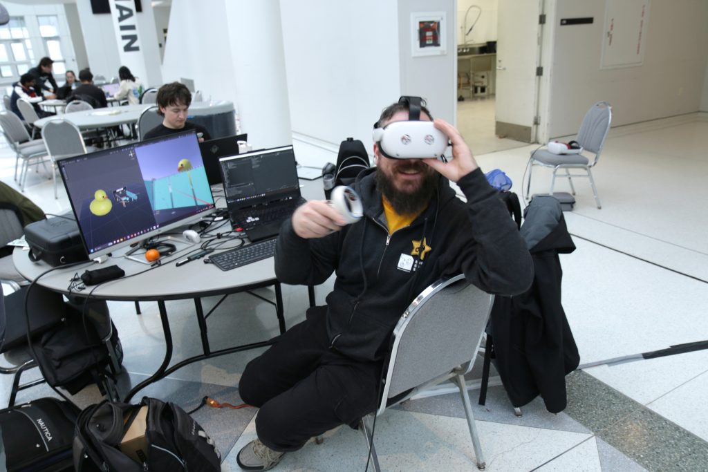 A jammer tests their game in a virtual reality headset.