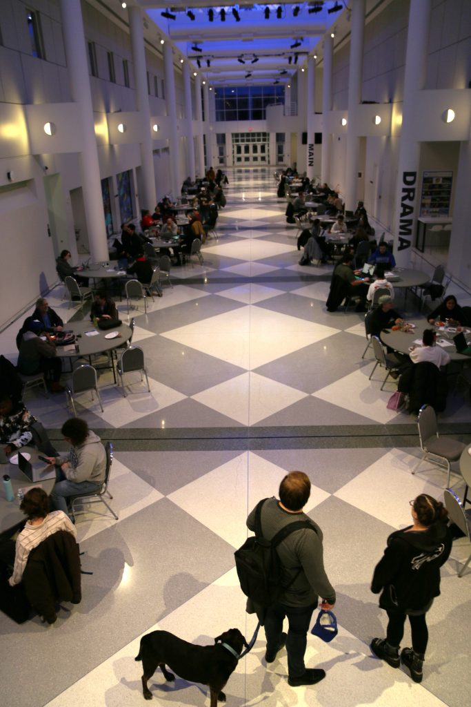 A picture of the Center for the Arts atrium as jammers get to work on the first night. Tables line the atrium with over 80 participants.