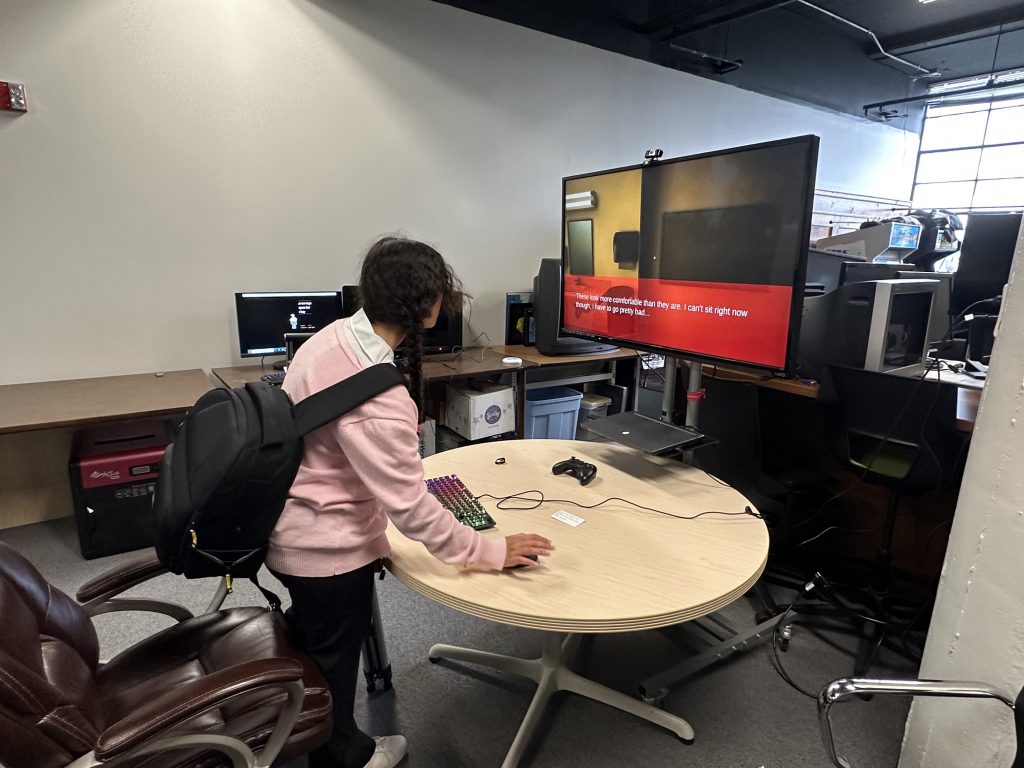 A participant plays Trans Folks Walking at the Buffalo Game Space, which housed the video game and virtual reality pieces.