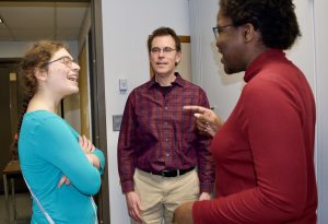 Dr. Peter with two students. 