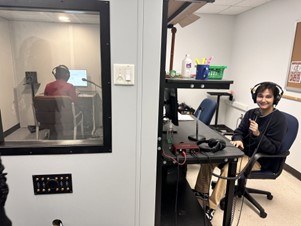 Students working in the lab wearing headphones