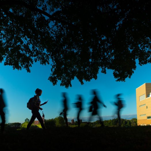 People walk on North Campus near Slee Hall and the Center for the Arts on an evening in September 2021. Photographer: Douglas Levere