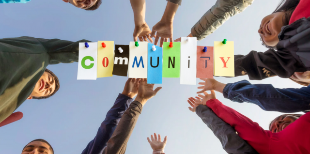 Hands high-fiving with the word "community" in the middle