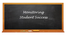 Monitoring student success on black chalk board