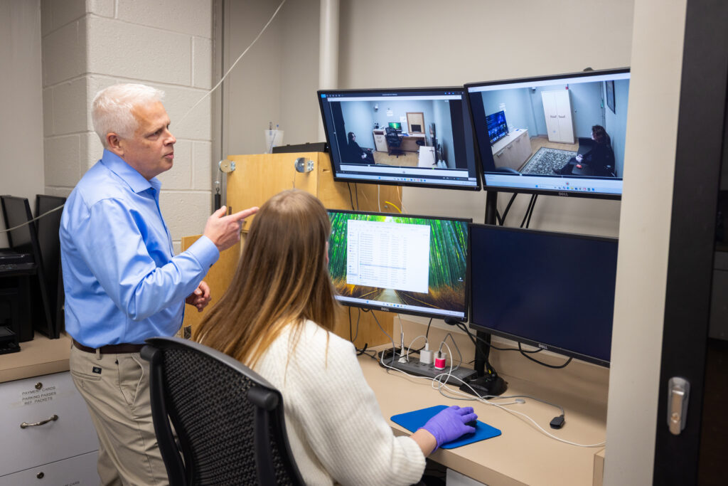 Dr. Larry Hawk and FRIENDS Project Coordinator, Ashley Schenkel observing a mock participant in our lab space located in Farber Hall