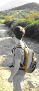 Pre-doctoral David Lacy looks off into the distance—thinking who-knows-what—on a hiking trail in sunny California. Perhaps he's looking for a reason to leave this beautiful place, a question he has yet to fully answer.