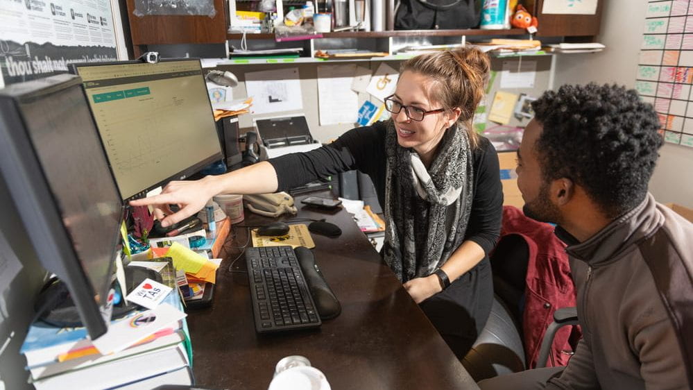 Professor talking with student in her office