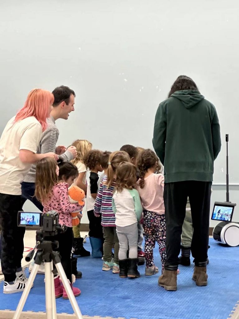 students gathered around a robot