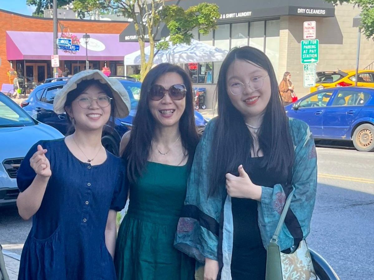 Grace, Joy, and Dr. Wang standing on a city street.