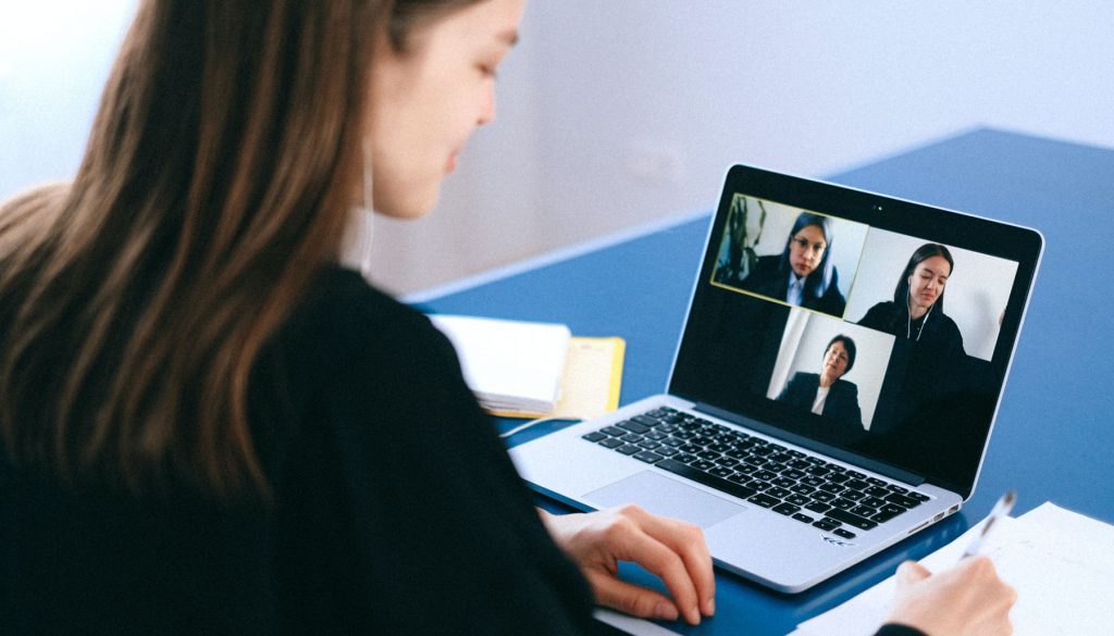 Woman leader videoconferences with her team.