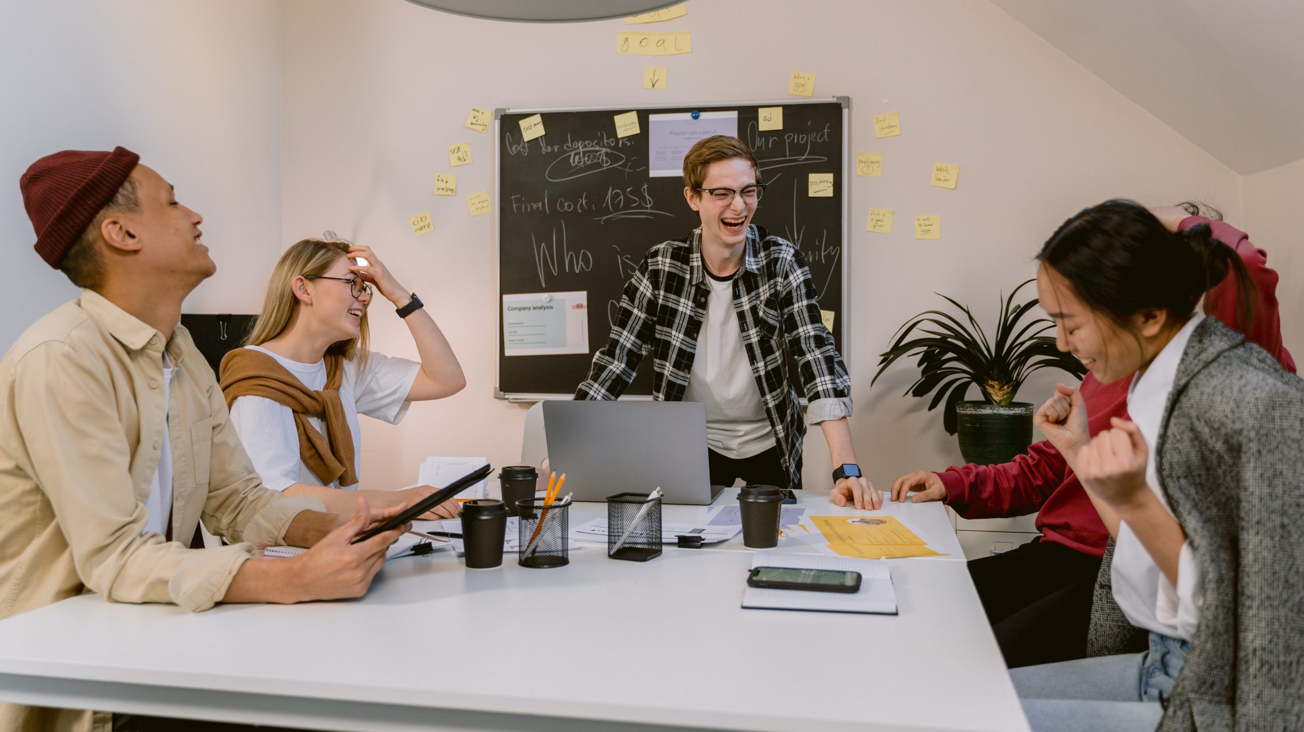 Colleagues laugh during a team meeting.