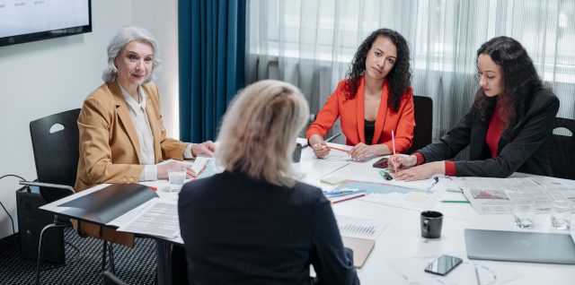 A manager leads her team in a meeting.