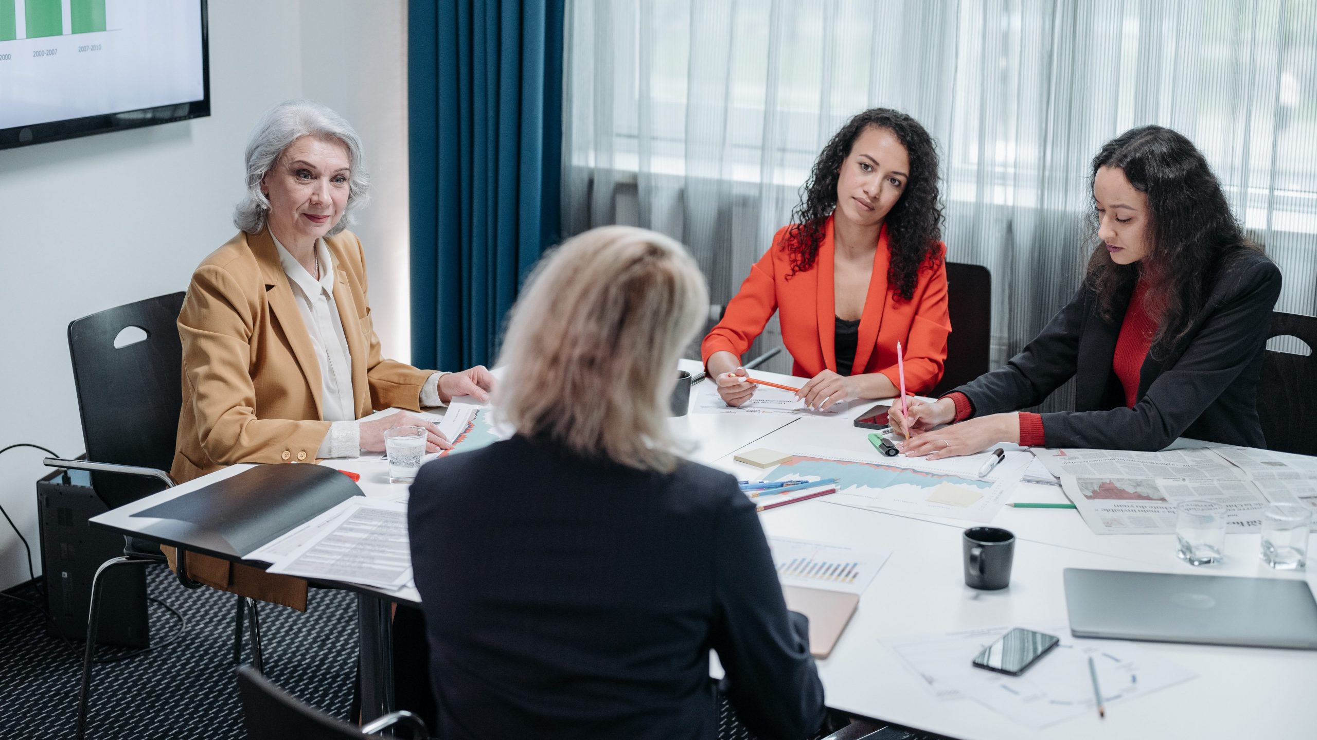 A manager leads her team in a meeting.