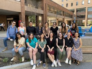 15 members of the lab sitting outside at UB.
