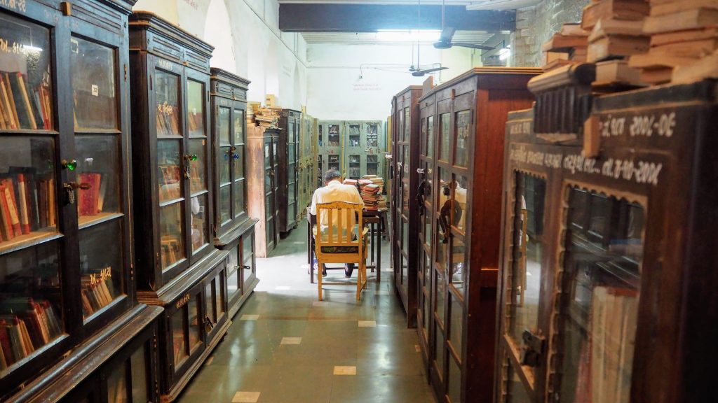 Man seated at table in Barton Library (Bhavnagar, Gujarat)