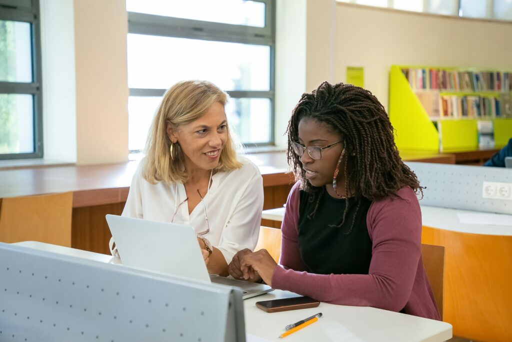 Two colleagues discussing information in an office setting.