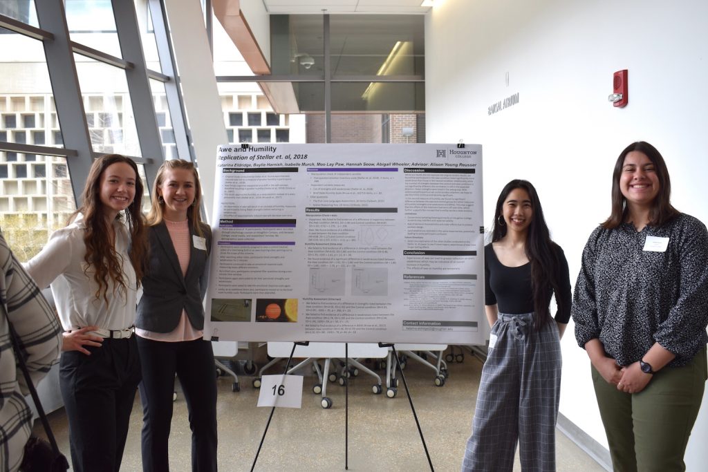 Four students near poster