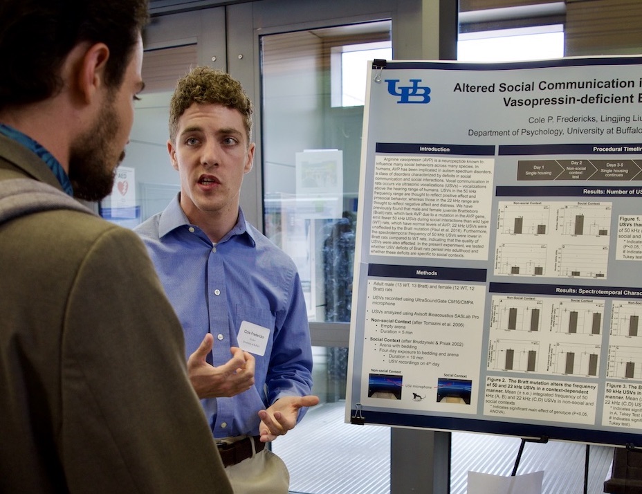 Cole Fredericks giving their poster presentation