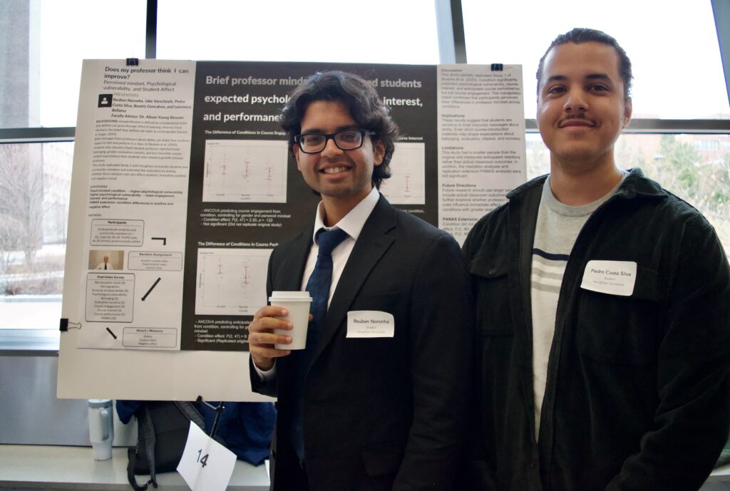 Reuben Noronha and Pedro Costa Silva standing in front of their poster